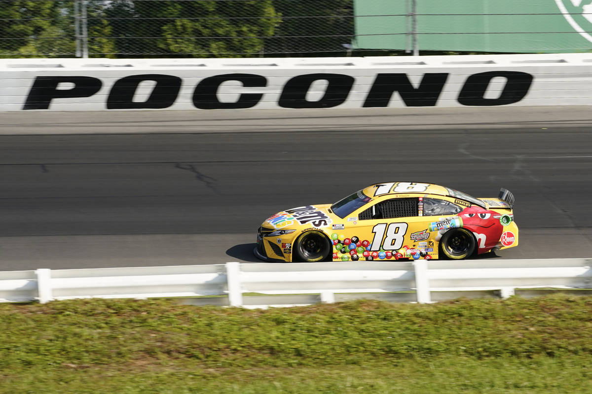 Kyle Busch (18) motors around the track during a NASCAR Cup Series auto race at Pocono Raceway, ...