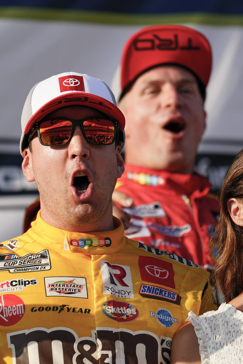 Kyle Busch, left, celebrates with teammates after winning a NASCAR Cup Series auto race at Poco ...