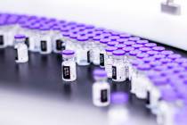 In this March 2021 photo provided by Pfizer, vials of the Pfizer-BioNTech COVID-19 vaccine are ...