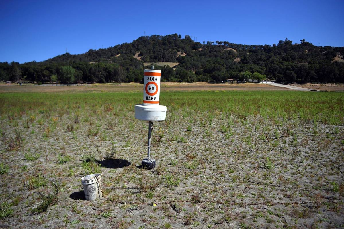 A buoy sits on dry land that had been under water, at a drought-stricken Lake Mendocino, in Uki ...
