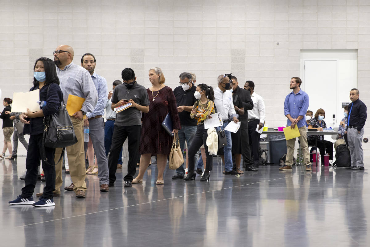 Job-seekers wait in line for the Amazon booth during a summer job fair hosted by Clark County a ...