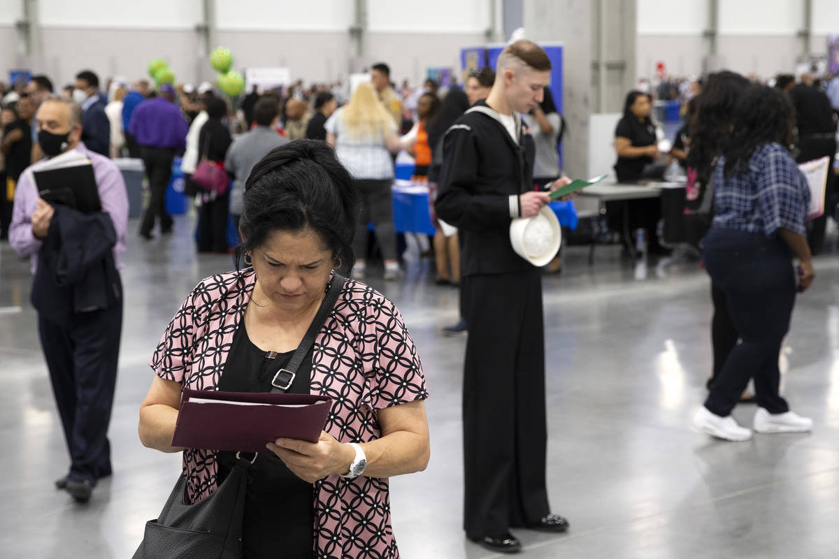 Job-seekers review the 14,000 positions available during a summer job fair hosted by Clark Coun ...