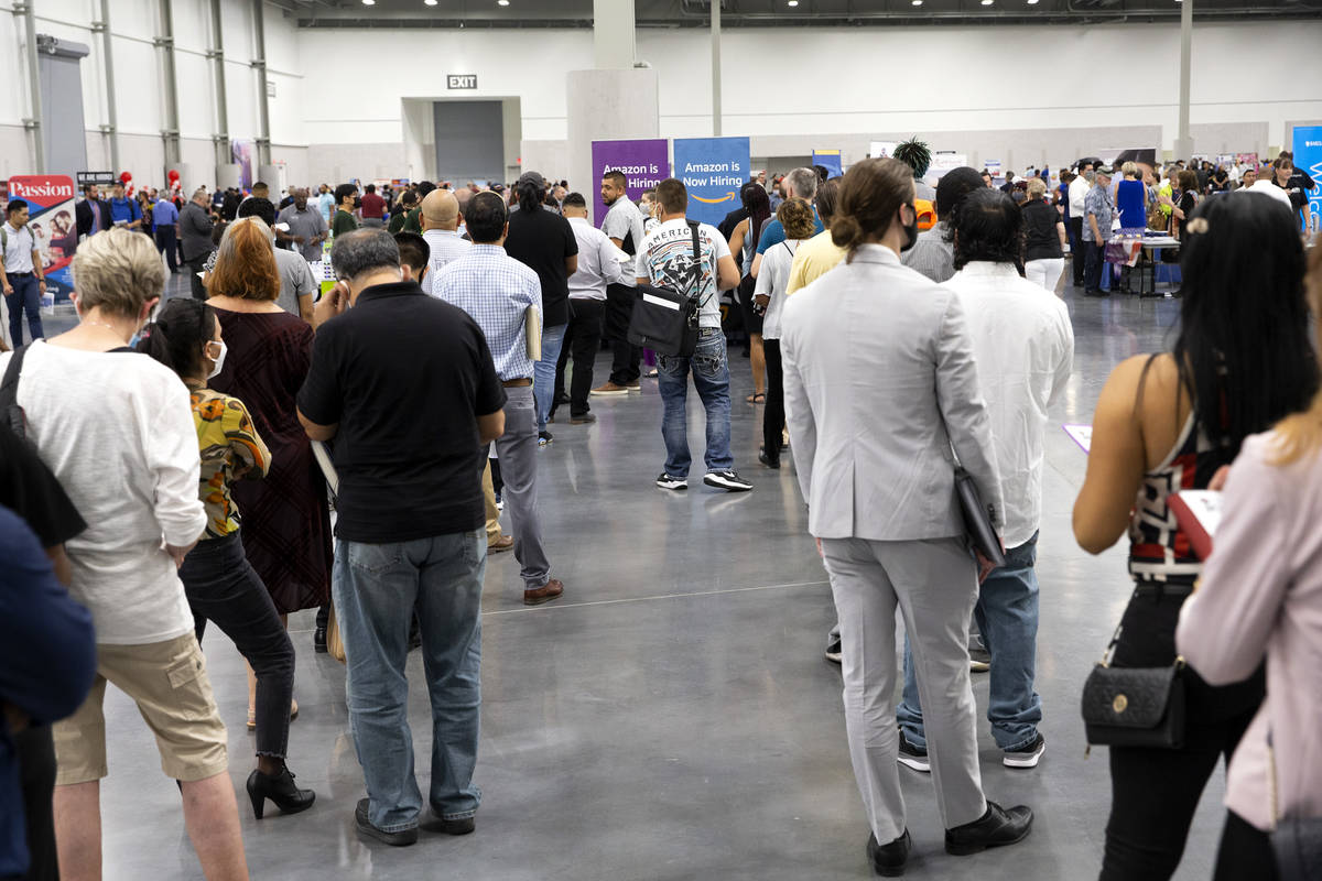 Job-seekers wait in line for the Amazon booth during a summer job fair hosted by Clark County a ...