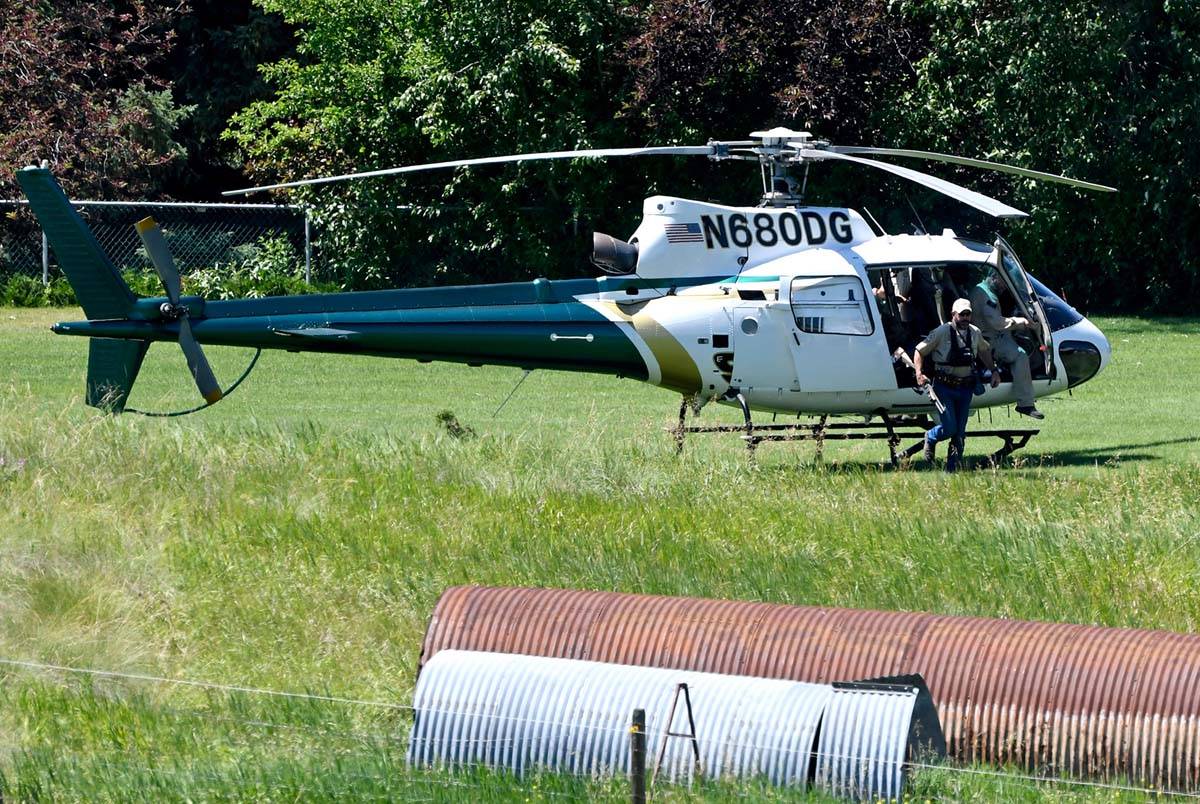A Montana Department of Fish, Wildlife and Parks helicopter lands in Ovando, Mont., on Tuesday, ...