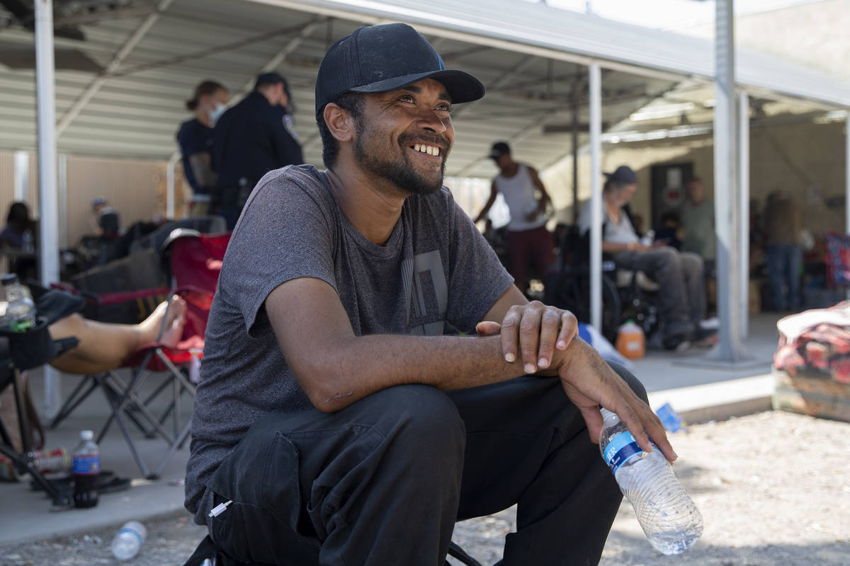 Toni Joseph, who was raised in Las Vegas, laughs with another person getting water and shade at ...