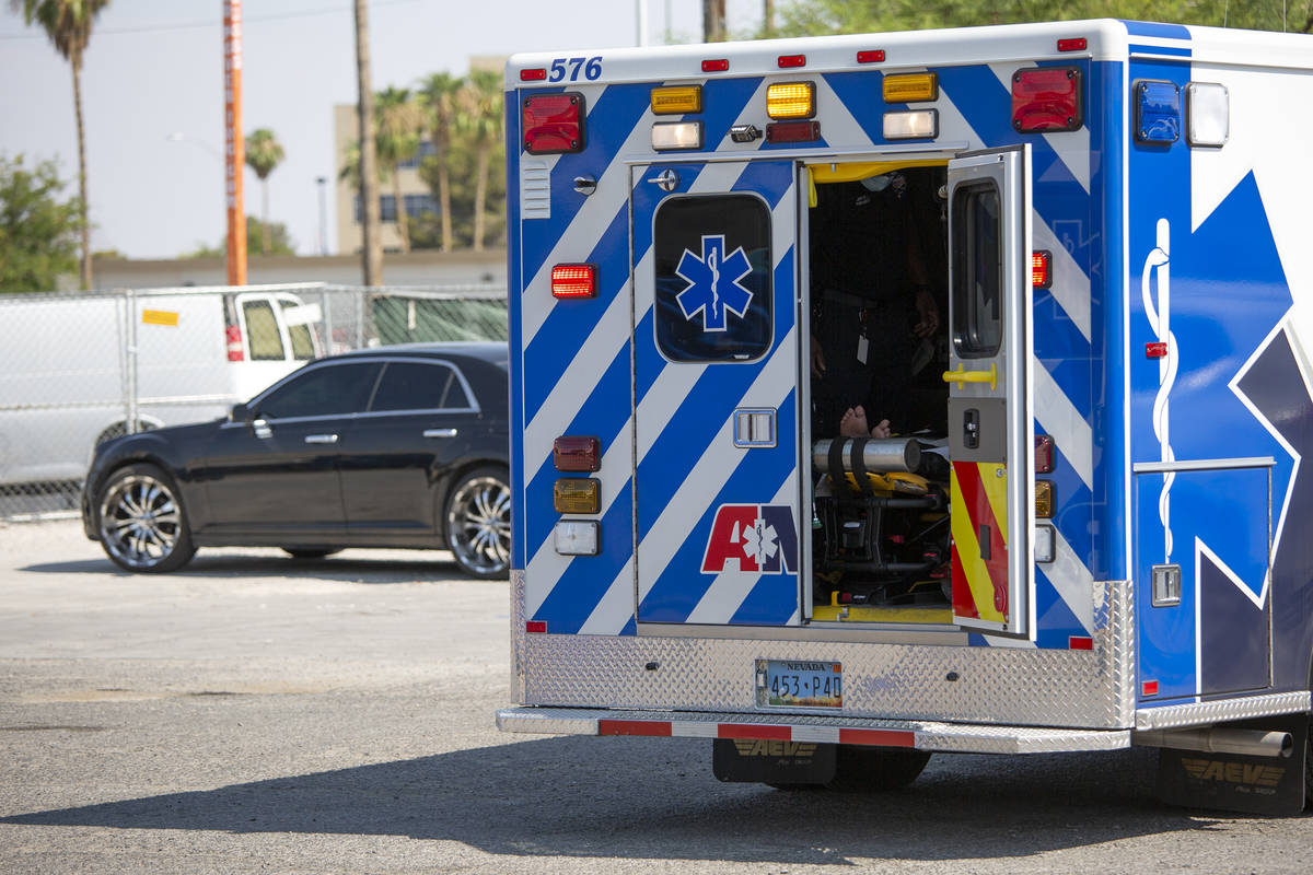 Paramedics ready a dehydrated person to go to the hospital from Courtyard Homeless Resource Cen ...