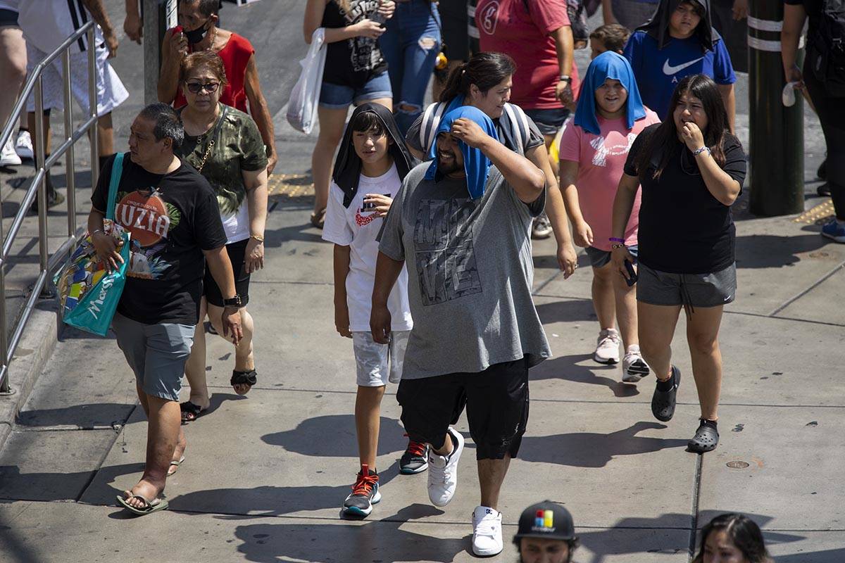 People walk on the Strip near the Park MGM hotel-casino in Las Vegas, Saturday, July 10, 2021. ...