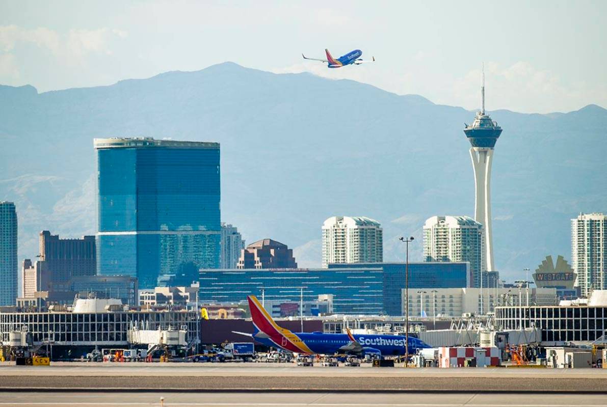 A Southwest plane departs as heat is causing travel delays at McCarran International Airport on ...