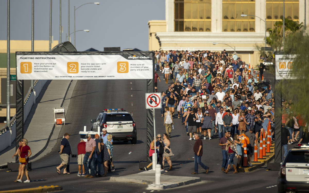 Fans make their way across the Hacienda overpass in the heat to the Garth Brooks concert at All ...