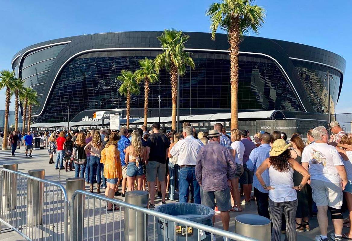 Attendees for a Garth Brooks concert line up at Allegiant Stadium about two hours before the sc ...