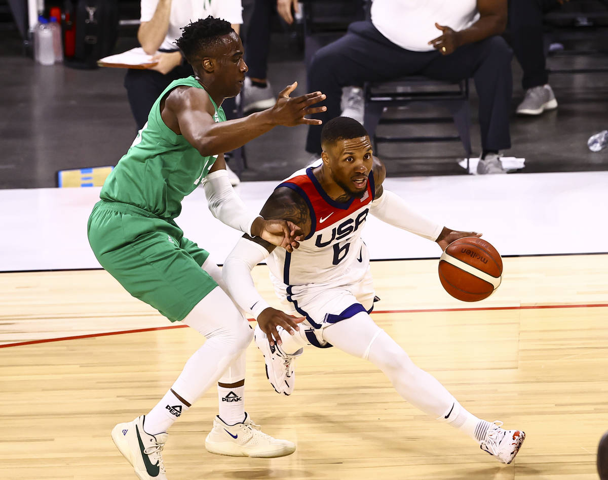 USA Basketball's Damian Lillard (6) drives the ball under pressure from Nigeria’s Miye O ...