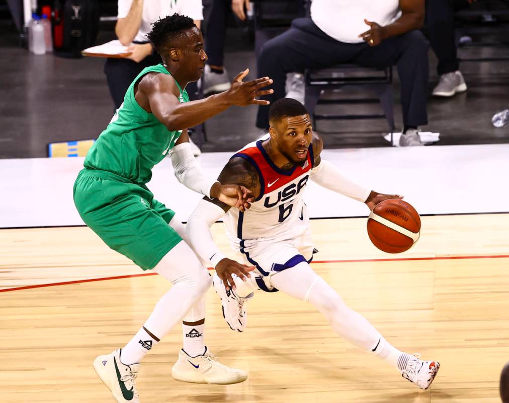 USA Basketball's Damian Lillard (6) drives the ball under pressure from Nigeria’s Miye O ...