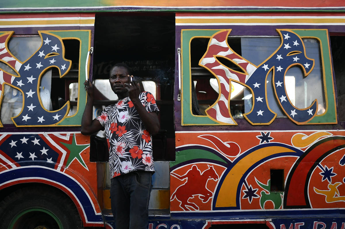 A worker waits for customers at a bus terminal in Port-au-Prince, Haiti, Saturday, July 10, 202 ...