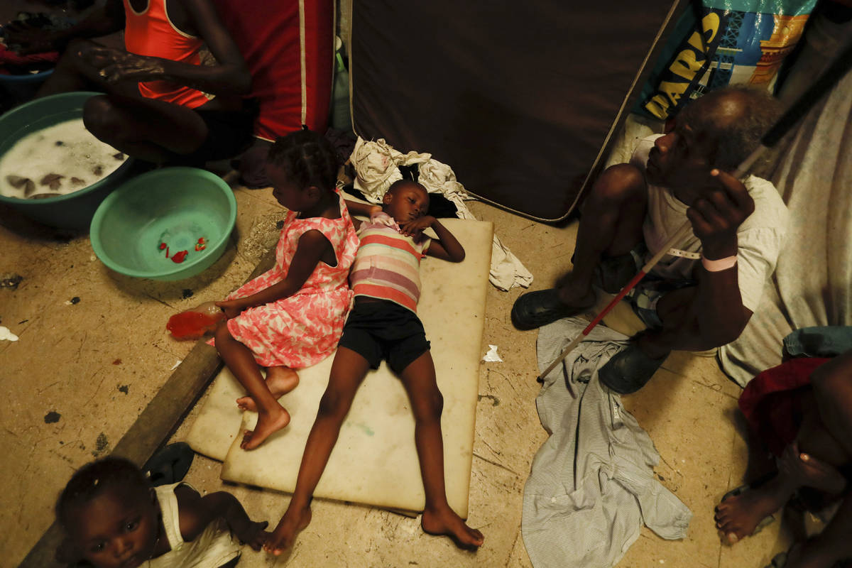 A boy lies on pieces of foam at a shelter for displaced Haitians, in Port-au-Prince, Haiti, Sat ...