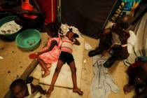 A boy lies on pieces of foam at a shelter for displaced Haitians, in Port-au-Prince, Haiti, Sat ...