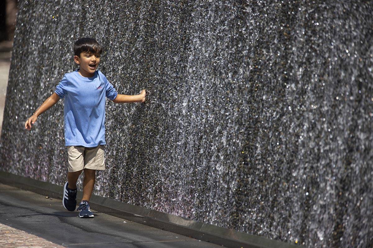 Ian Alaniz, 5, of Dublin, Texas, touches a water feature outside of New York-New York Hotel-Cas ...