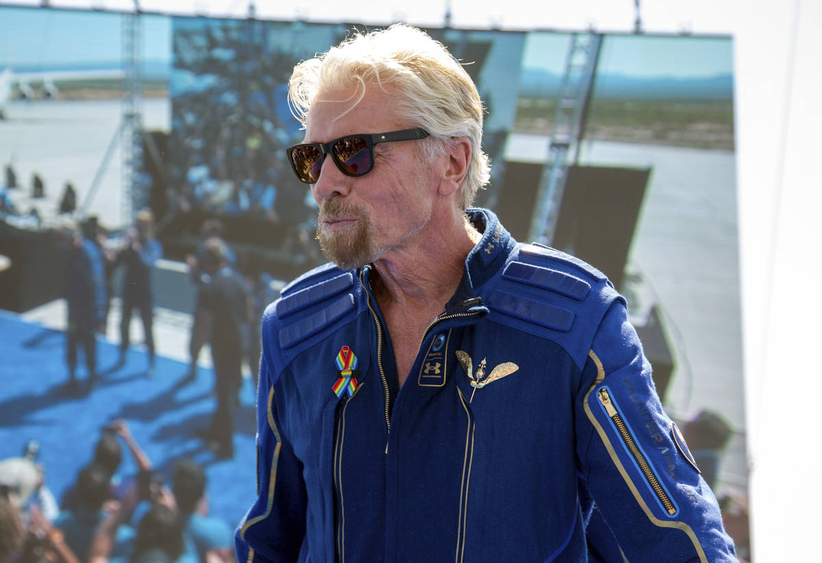 Virgin Galactic founder Richard Branson shows his astronaut wings pin after his flight to space ...