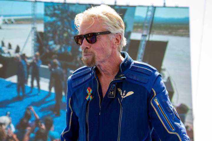 Virgin Galactic founder Richard Branson shows his astronaut wings pin after his flight to space ...