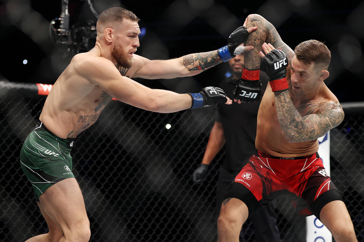 Conor McGregor, left, and Dustin Poirier, battles in the first round of a lightweight bout agai ...