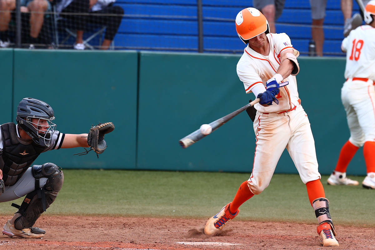 Bishop Gorman HighÕs right fielder Tyler Whitaker connects with the ball against Palo Verd ...