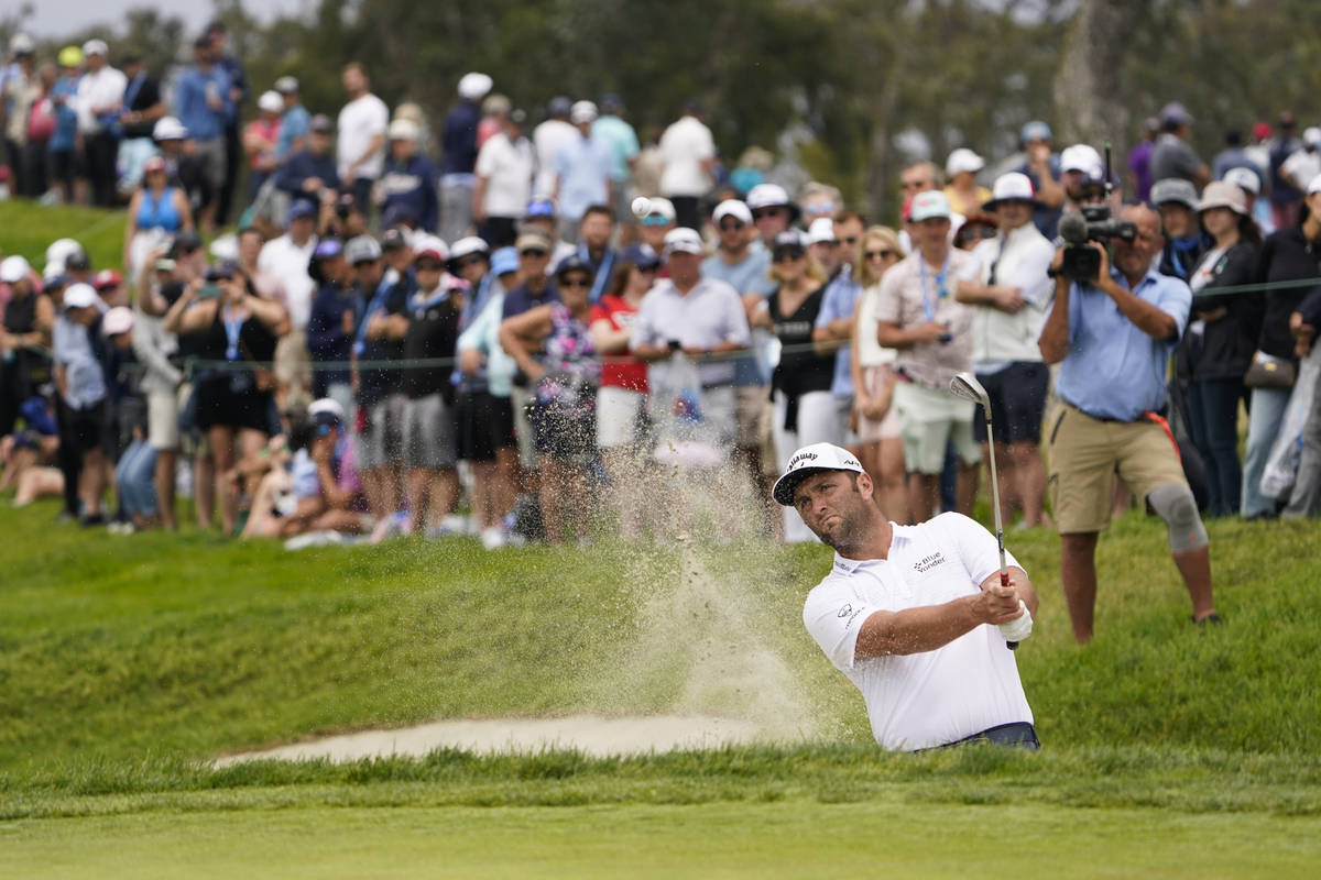 Jon Rahm, of Spain, hits out of a bunker during the third round of the U.S. Open Golf Champions ...