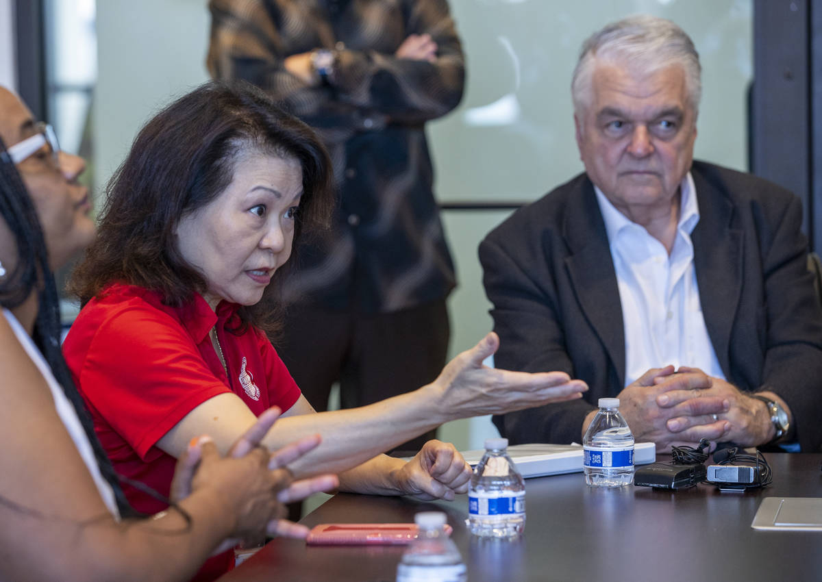 Vida Lin with the Asian Community Development Council, left, with Governor Steve Sisolak speaks ...