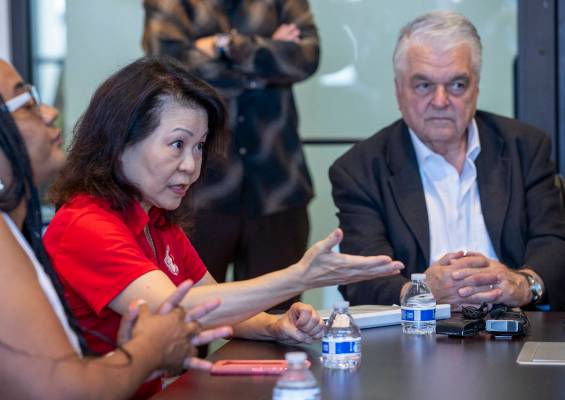Vida Lin with the Asian Community Development Council, left, with Governor Steve Sisolak speaks ...