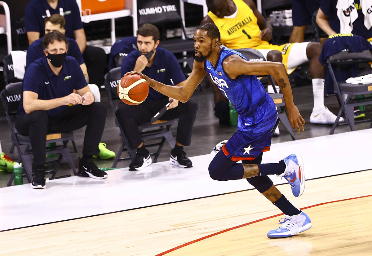 USA’s Kevin Durant brings the ball up court against Australia during the first half of a ...