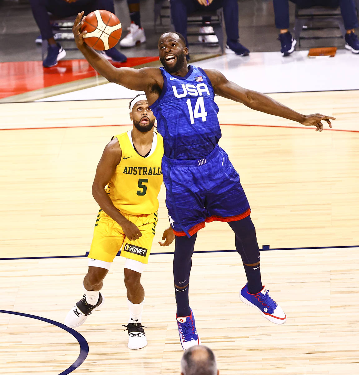 USA’s Draymond Green (14) reels in a pass in front of Australia's Patty Mills (5) during ...