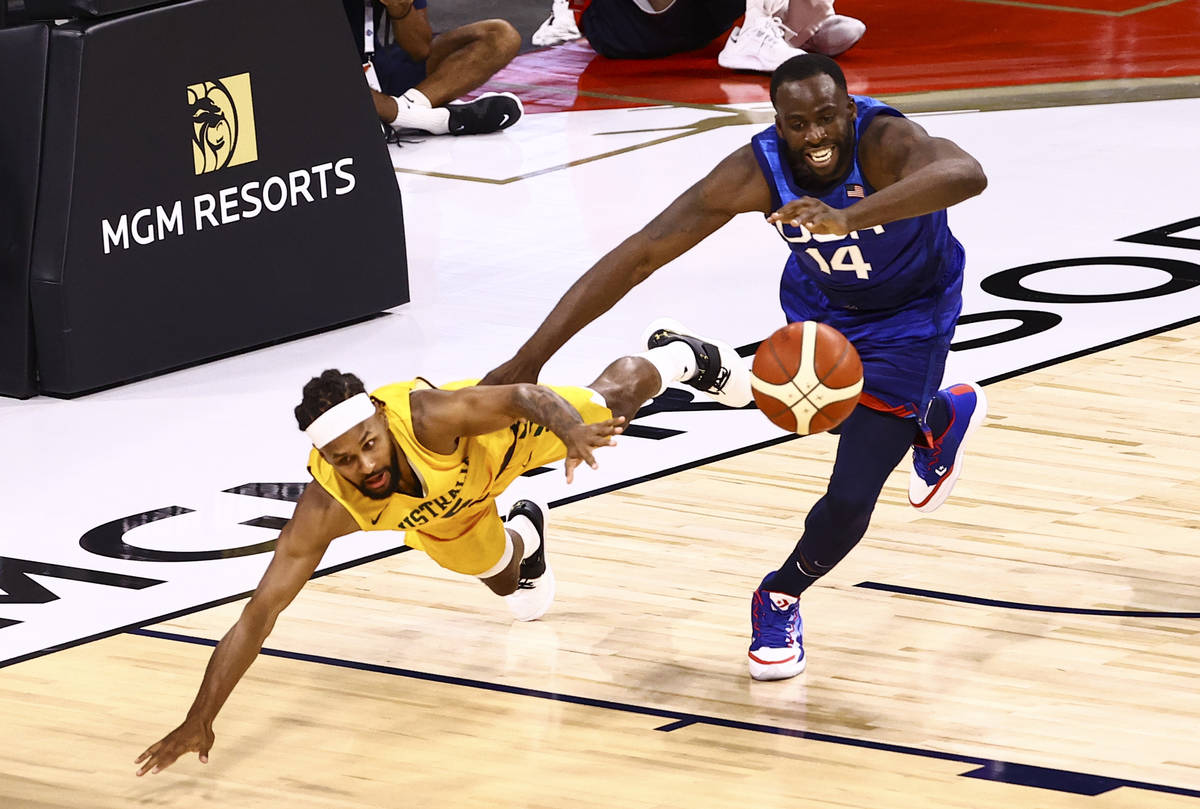 Australia's Patty Mills, left, and USA’s Draymond Green (14) battle for a loose ball dur ...