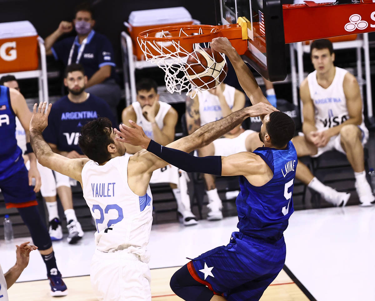 USAÕs Zach Lavine (5) dunks the ball while being fouled by ArgentinaÕs Juan Pablo Vaulet (22) ...