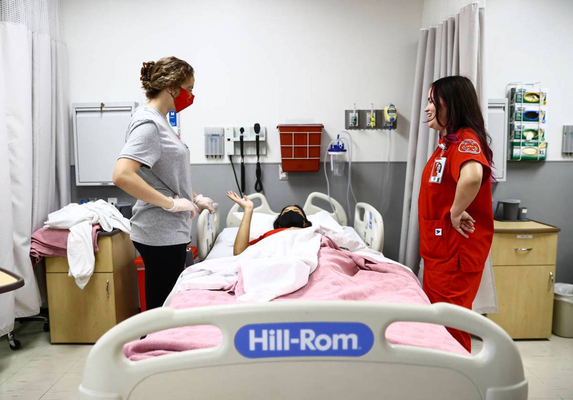 West Career & Technical Academy student Jenna Le Piere, left, learns about hospital bed orienta ...