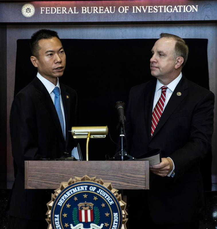 Acting U.S. Attorney Christopher Chiou, left, speaks about a global law enforcement action as S ...