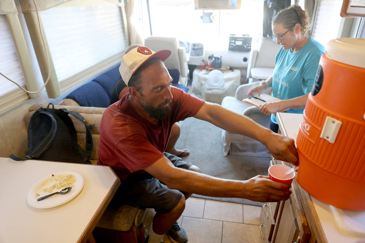 Eric Gutierrez, 39, grabs a cup of lemonade while waiting for his shower in an RV operated by C ...