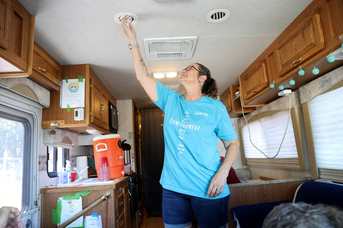 Cup of Hope outreach ministry co-founder Valerie Johnson adjusts an air conditioning vent in th ...