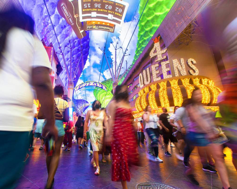 Visitors take in the sites at the Fremont Street Experience during Memorial Day weekend on Satu ...