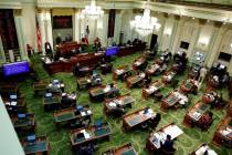 Members of the state Assembly meet at the Capitol in Sacramento, Calif., in May 2020. (AP Photo ...