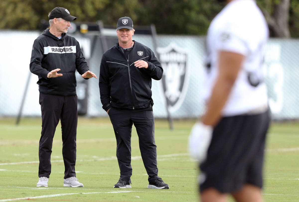 Oakland Raiders general manager Mike Mayock, left, and head coach Jon Gruden watch the team pra ...