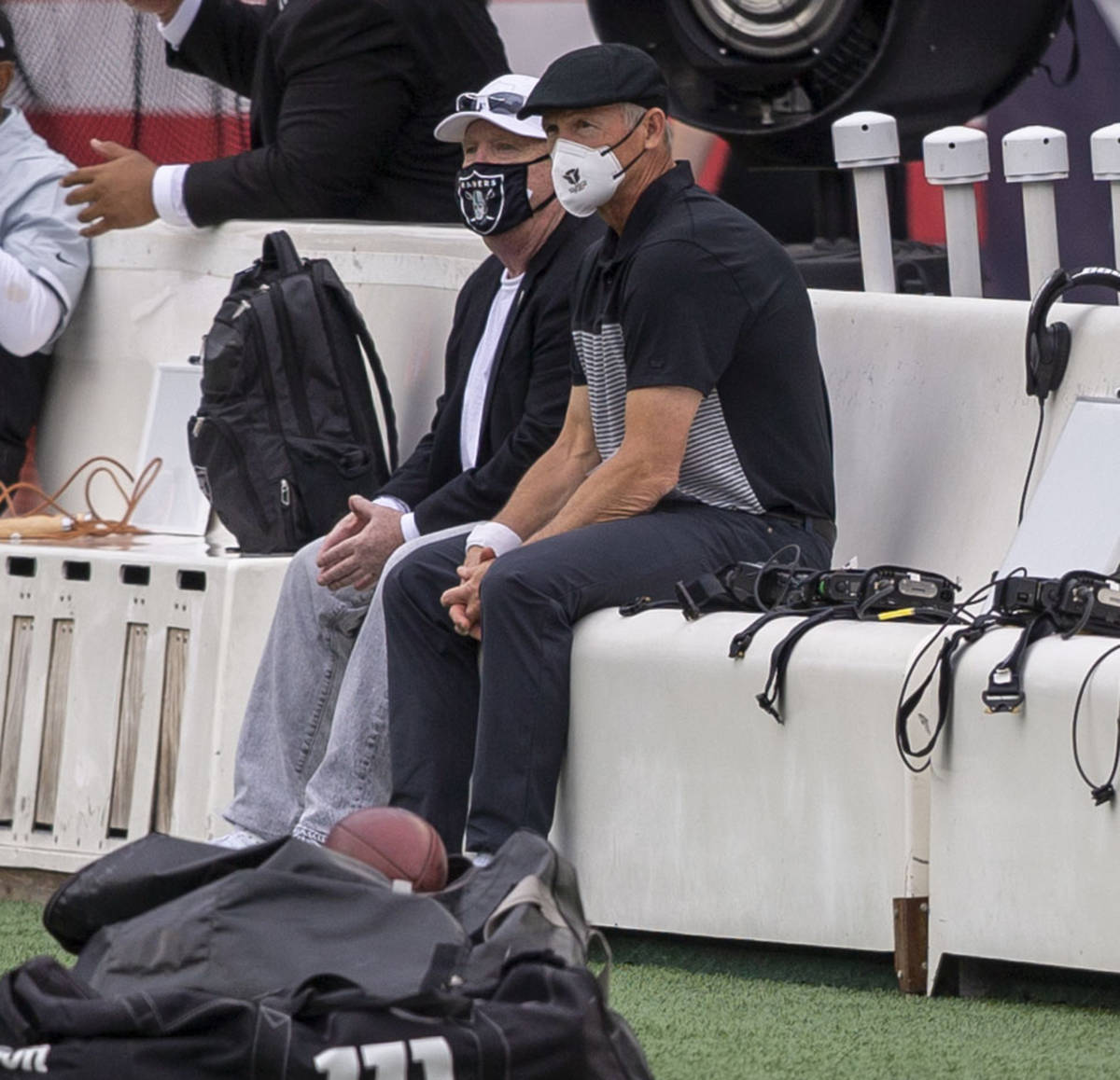 Las Vegas Raiders owner Mark Davis, left, watches team warm ups with general manager Mike Mayoc ...