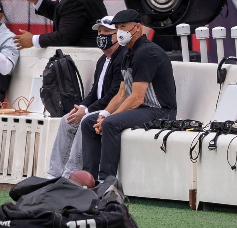 Las Vegas Raiders owner Mark Davis, left, watches team warm ups with general manager Mike Mayoc ...