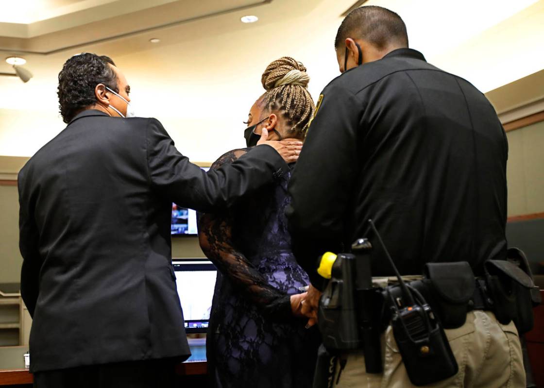 Cadesha Bishop is taken into custody as her attorney Michael Castillo, left, speaks to her afte ...