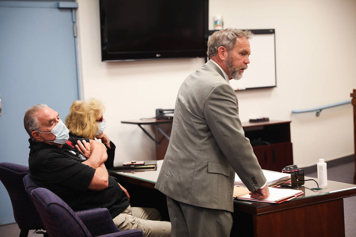 Marcel Chappuis sits with his wife, Patricia, as their defense attorney, Thomas Gibson, speaks ...