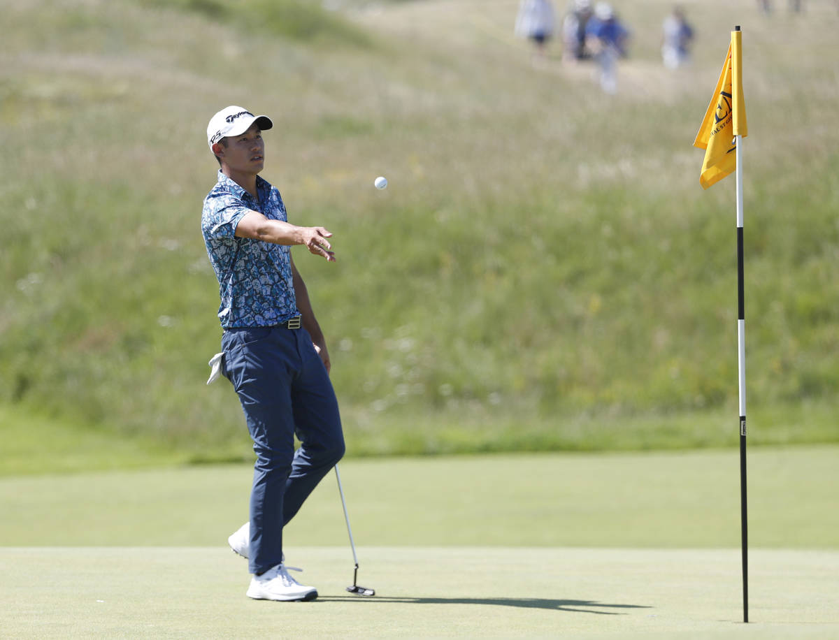 United States' Collin Morikawa gives his ball to his caddie on the 3rd hole during the final ro ...
