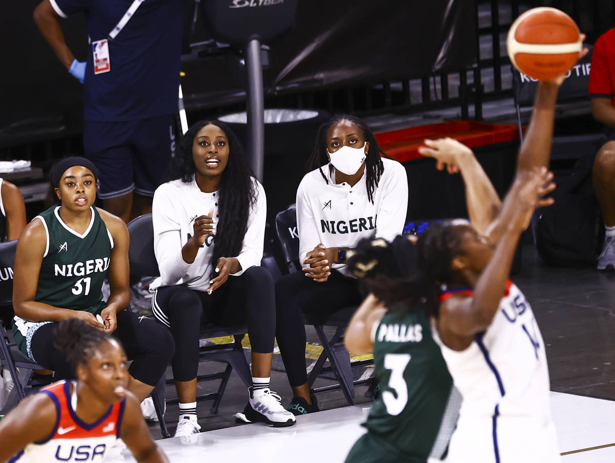 Nigeria guard Erica Ogwumike (31), left, watches the action alongside sisters Chiney Ogwumike, ...