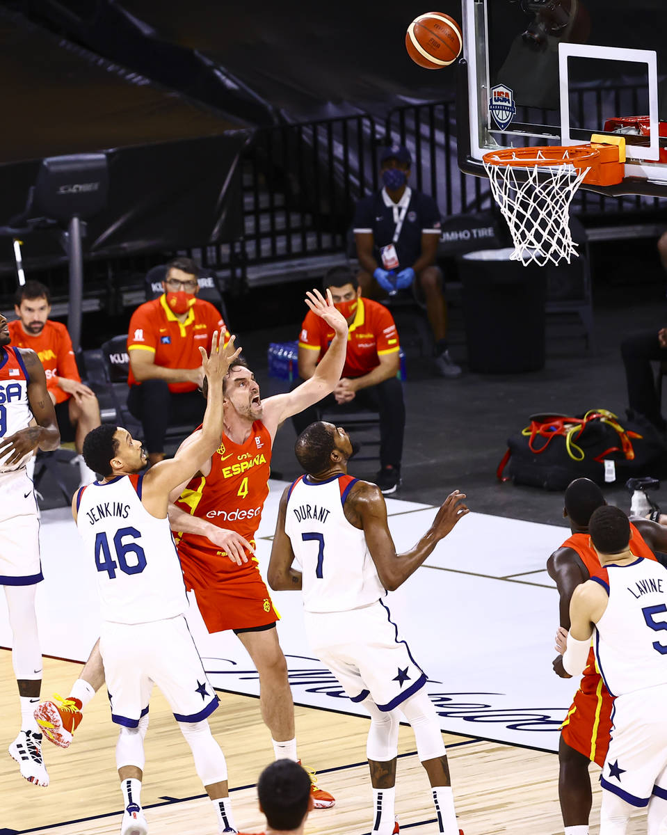 Spain center Pau Gasol (4) lays up the ball between United States guard John Jenkins and forwar ...