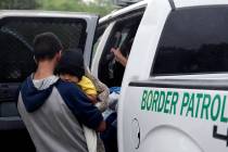 FILE - In this March 14, 2019, file photo, families who crossed the nearby U.S.-Mexico border n ...