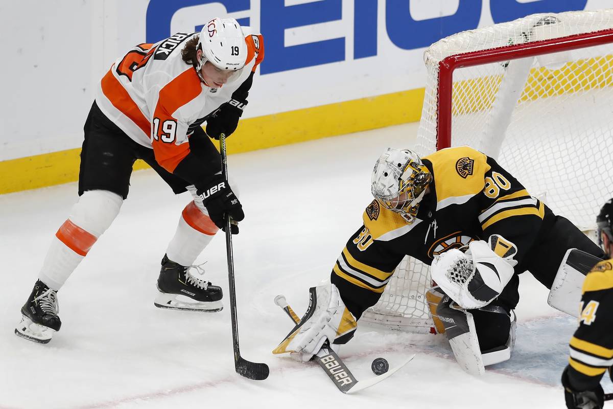 Boston Bruins' Dan Vladar, right, blocks a shot by Philadelphia Flyers' Nolan Patrick, left, du ...