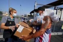 Los Angeles Unified School District food service worker Marisel Dominguez, left, distributes fr ...