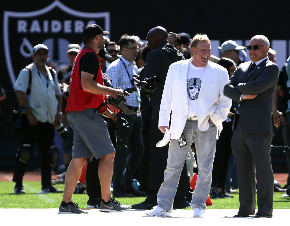 Raiders owner Mark Davis, in white, and president Marc Badain, right, share a laugh before an N ...