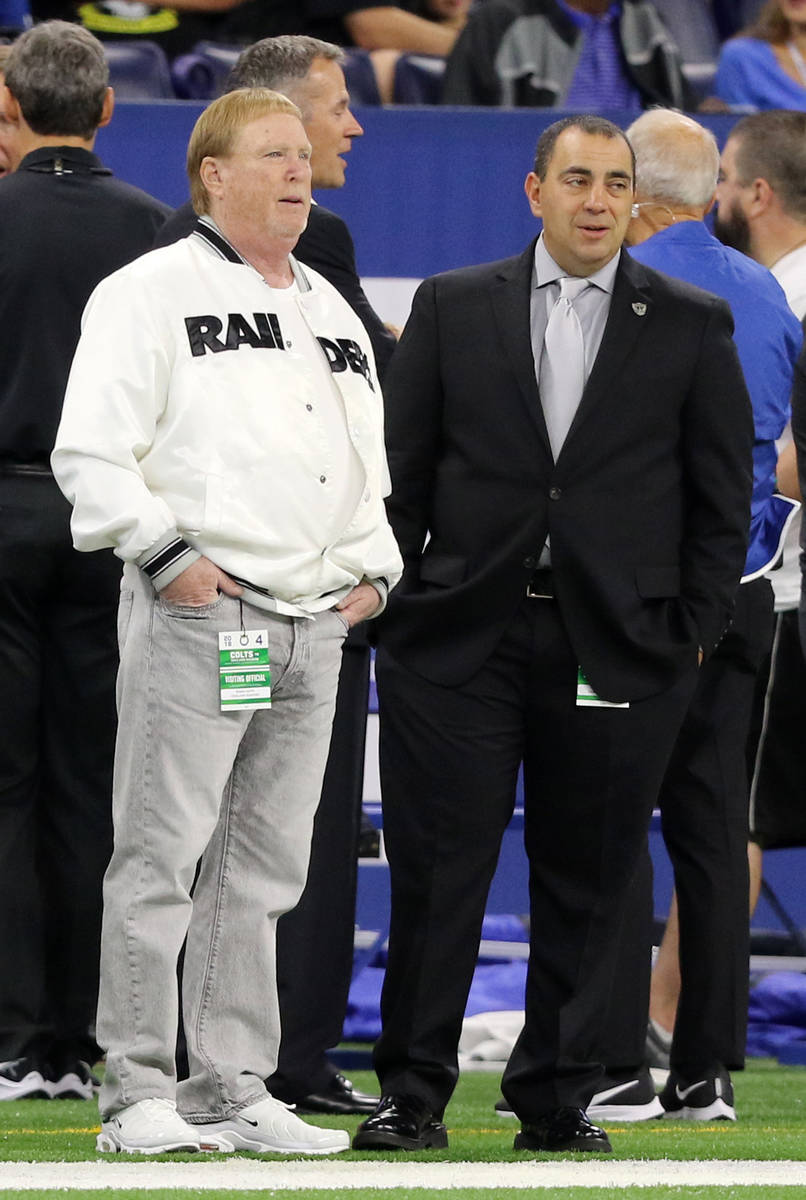 Raiders owner Mark Davis, left, speaks on the sideline with executive vice president and genera ...